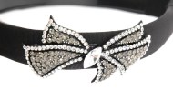 This black headband decorated with tons of Swarovski crystals measures approximately 0.75 inches thick at center. The ornamentation is about 2.75 inches by 1.75 inches. G3