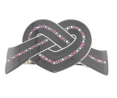 This medium size plastic barrette measures about 3.5 inches wide and 2.0 inches high. The clasp on the back is about 2.5 inches long. P19