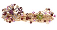 This medium size barrette decroated with tons of crystals measures about 3.75 inches wide and 1.5 inch high.  The clasp on the back is about 2.25 inches long. P1
