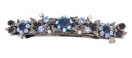 This barrette decorated with SWAROVSKI crystals measures about 4.0 inches wide and 0.75 inch high. The clasp on the back is about 3.0 inches long. P5