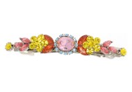 This medium size barrette decorated with SWAROVSKI crystals measures about 2.75 inches wide and 0.5 inch high. The clasp on the back is about 1.5 inches long. P4