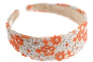 The comfortable headband is covered with colorful fabric and measures approximately 1.5 inches thick at center. One size. G1