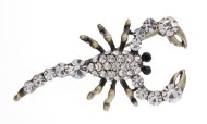 This SWAROVSKI crystal scorpion brooch with measures approximately 1.8 inch wide and 0.8 inch high.